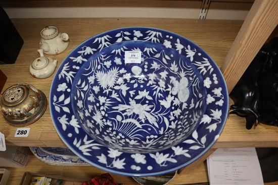A 19th century Chinese white slip decorated blue ground basin diameter 34cm
